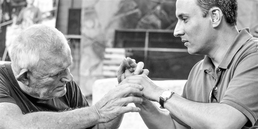 Two people using tactile sign language.